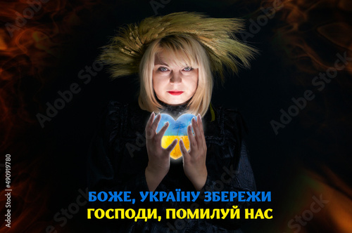 Pray for Ukraine, Stand with Ukraine. Beautiful Ukrainian woman in wreath of wheat holds a heart in the national colors of Ukraine in her hands. Stop war against Ukraine 