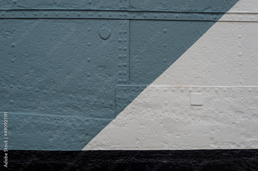 Fototapeta premium metal sheets riveted together and painted grey, white and black. Part of a ships hull.