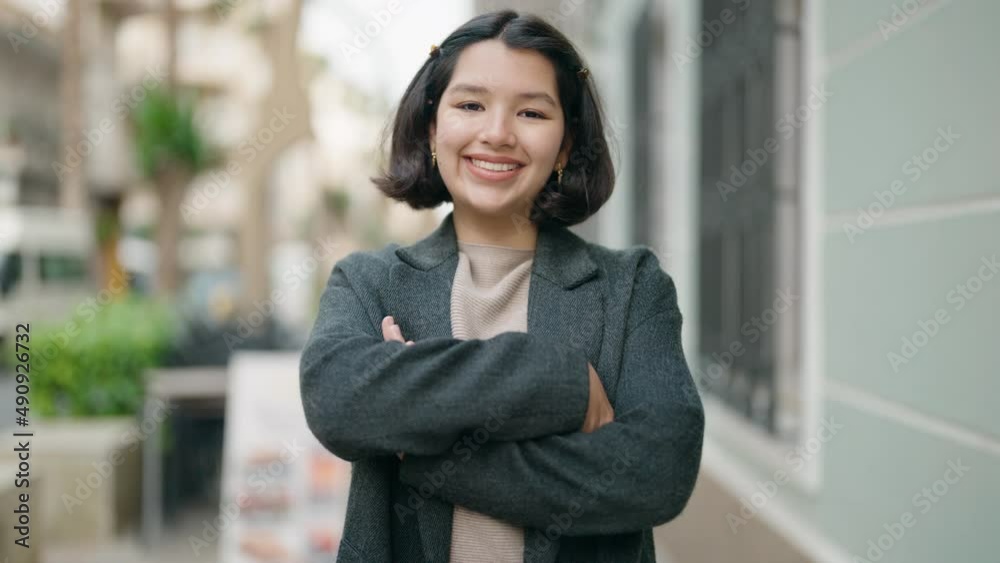 Young hispanic girl smiling confident standing with arms crossed gesture at street Young hispanic girl smiling confident standing with arms crossed gesture at street
