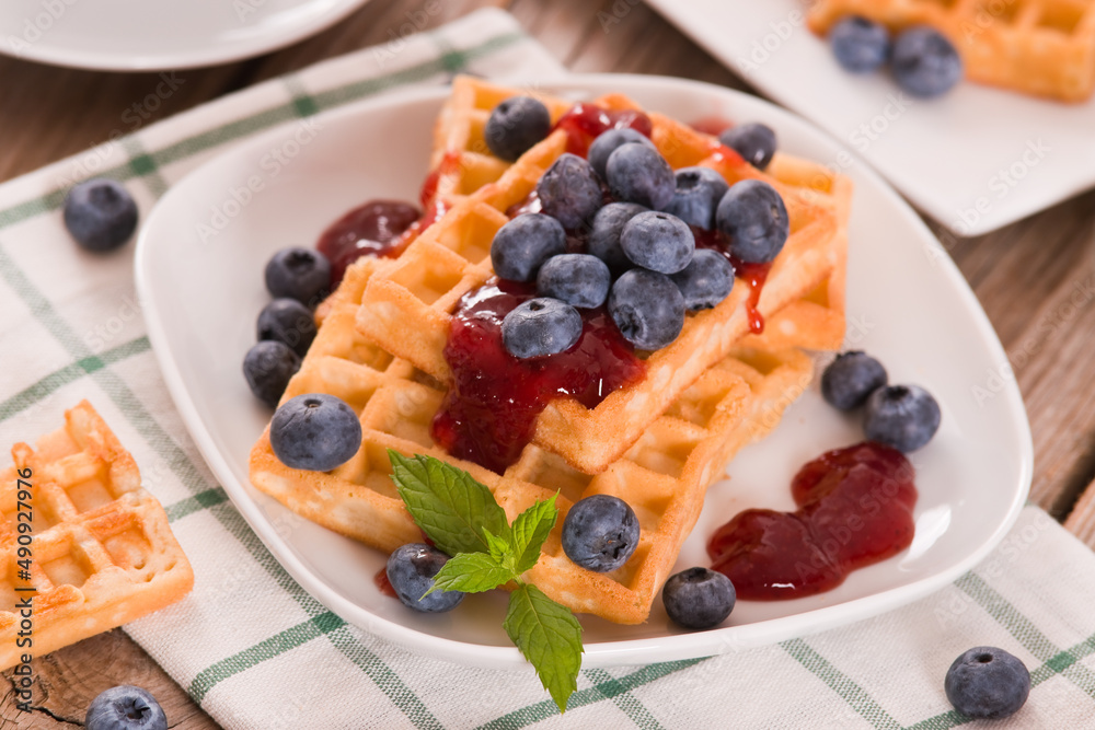 Waffles with blueberries and jam. 