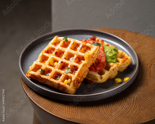 Belgian cheese waffles with guacamole, tomato and syrup