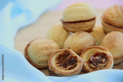 cookies in the form of nuts with condensed milk on a blue background