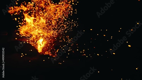 Bonfire in nature. Fire space close up view. Bright stream burn sparks are fly in the camera, at you, into the lens. Slow motion magic cinematic bokeh beautiful flame. Fire defocus, Blur, Bokeh.