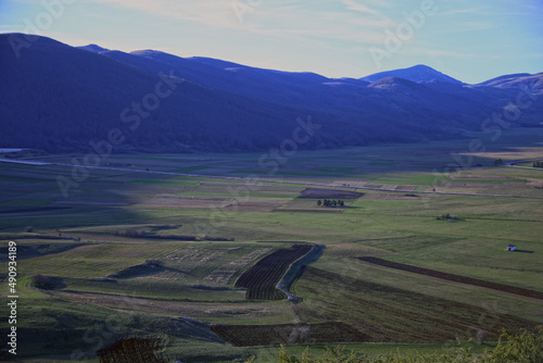 Top view of cultivated fields in the Piano Delle Cinquemiglia, surrounded by mountains, at dusk, Roccaraso, Abruzzo, Italy photo