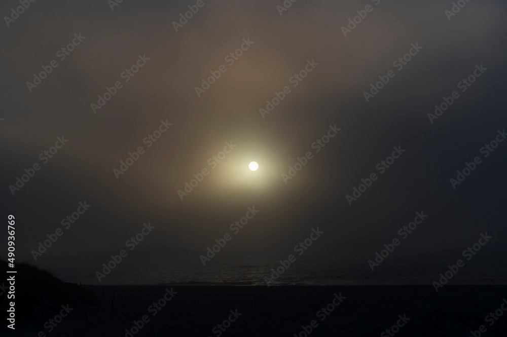 Foggy coastal sunset.