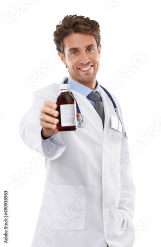 If you want that cough to go away.... Studio shot of a positive-looking young doctor holding bottle up to the camera.