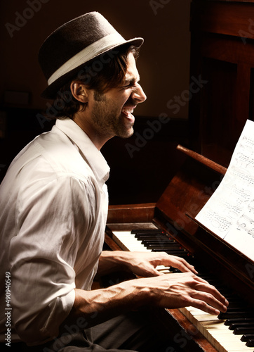 Photography Hes got soul. Profile of a handsome man playing the piano.