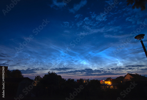 beautiful display of rare and bright noctilucent clouds over Germany in a summer night on the 21st June 2019. Scenic landscape in the dawn with copy space.