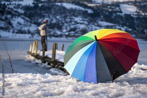 Snow on winter day and a colorful umbrella