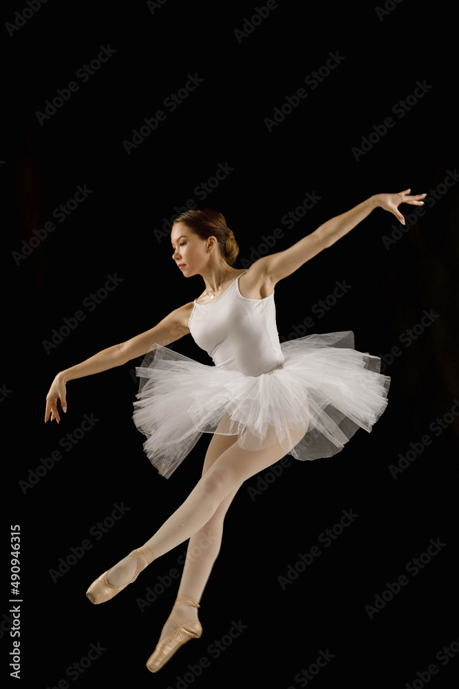 girl-dancer in a jump on a black background