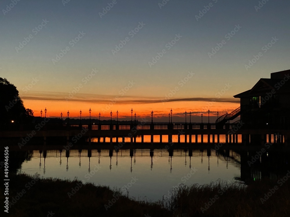 Bridge with reflection at sunrise on lake
