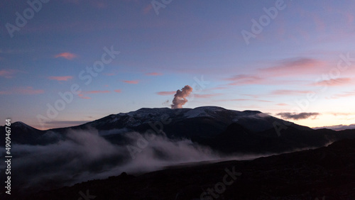 Nevado del Ruiz, active volcano in Colombia, vents smoke and gases before dawn photo