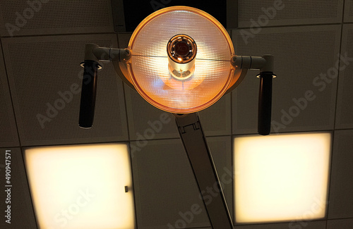 Special work lamp at a dental clinic with a bright light used for examination and operation photo