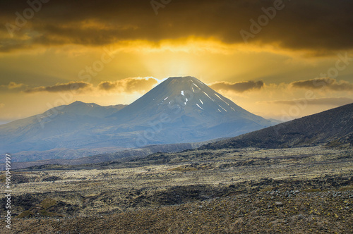 Mount Ngauruhoe in New Zealand, Mount Doom from The Lord of the Rings, under a dramatic evening sky, with volcanic wasteland in the foreground 