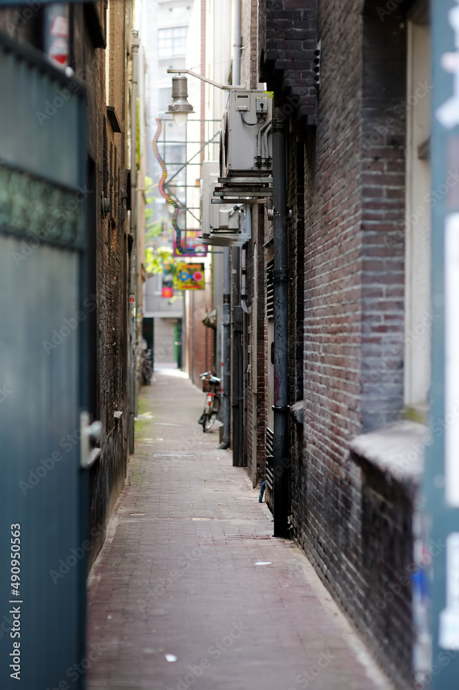 Narrow street between two houses in Amsterdam, Netherlands.