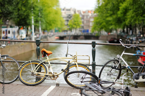 Bicycles parked on the bridge over canal in Amsterdam, Netherlands.
