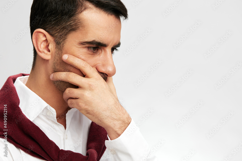 handsome businessman in a white shirt sweater on the shoulders pensive look light background handsome businessman in a white shirt sweater on the shoulders pensive look light background
