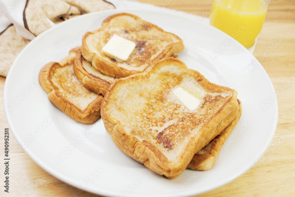 Fried French Toast served on a Plate with Butter Fried French Toast served on a Plate with Butter