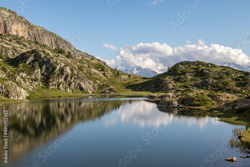 High altitude lake at the foot of the mountains and mountain ranges in the French Alpes