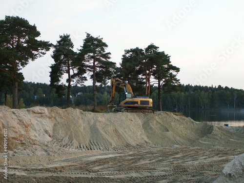 The excavator works on a sand quarry, construction equipment.