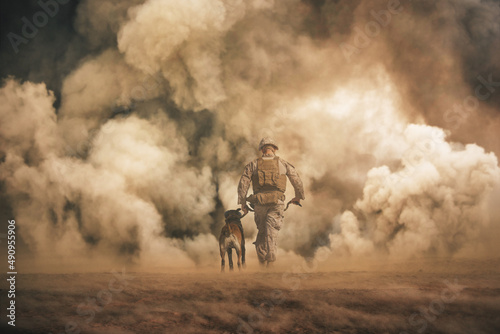 Military soldier with a dog between storm and dust at desert	 photo