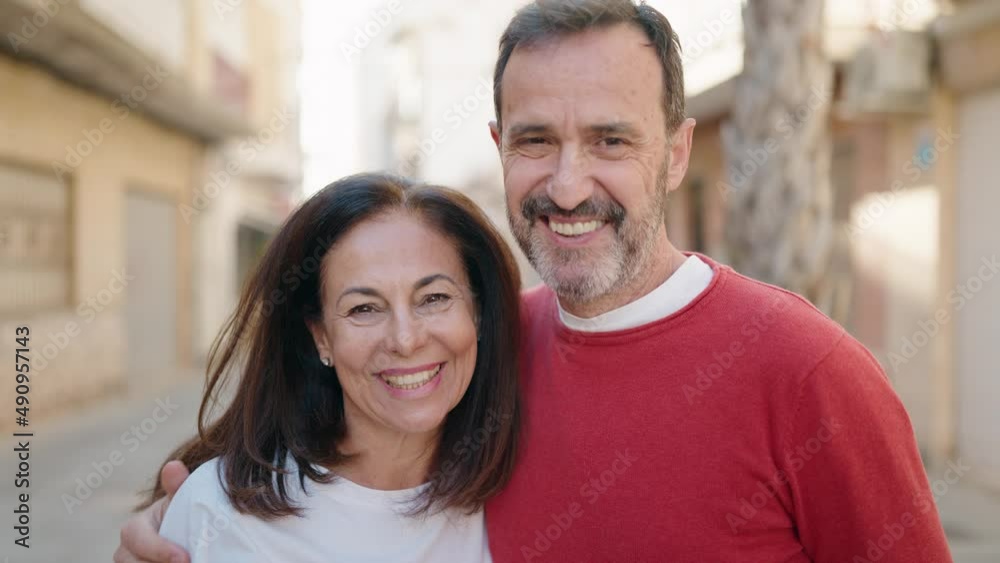 Man and woman couple hugging each other standing at street Man and woman couple hugging each other standing at street