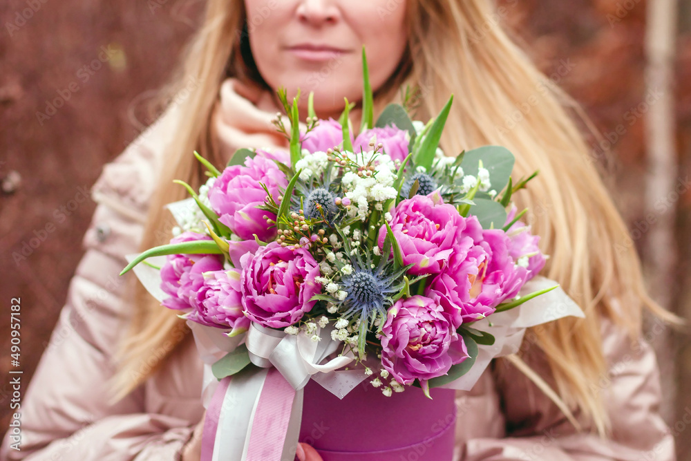 Beautiful bouquet of purple tulips in a box. Gift to a woman on International Women's Day. March 8 gift for women