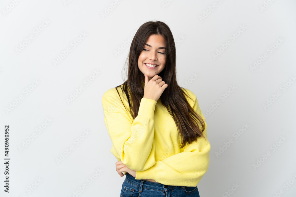 Teenager Brazilian girl isolated on white background looking to the side and smiling Teenager Brazilian girl isolated on white background looking to the side and smiling