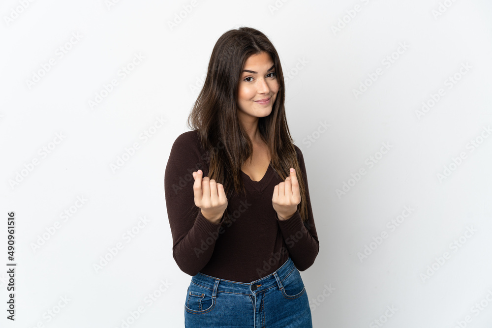 Fototapeta premium Teenager Brazilian girl isolated on white background making money gesture but is ruined