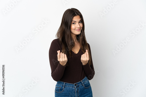 Teenager Brazilian girl isolated on white background making money gesture but is ruined