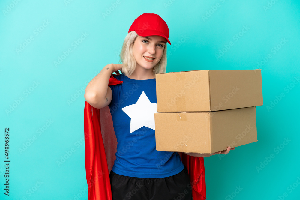 Super Hero caucasian delivery woman isolated on blue background laughing Super Hero caucasian delivery woman isolated on blue background laughing