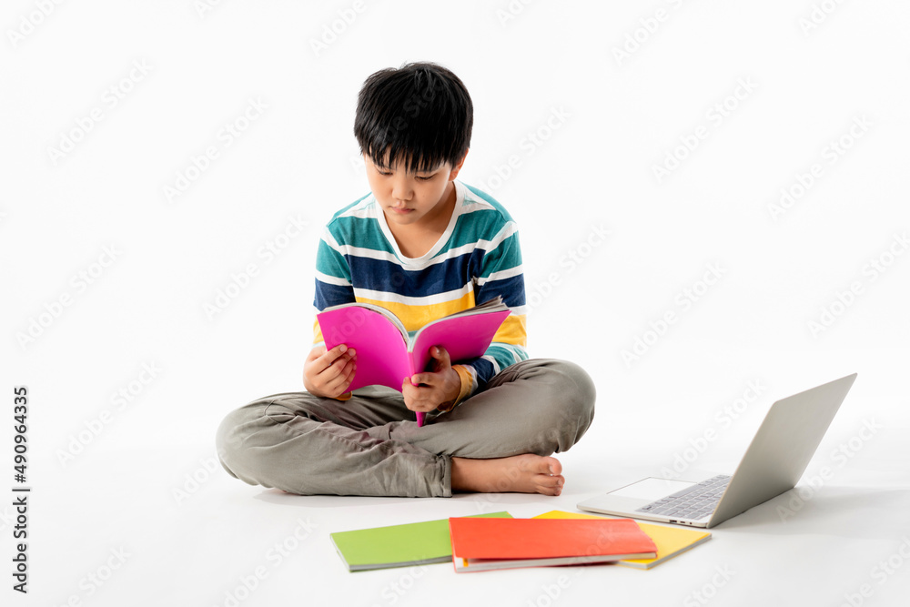 Portrait of Happy asian boy on floor with laptop and books isolated on white background, Education and learning with technology concept