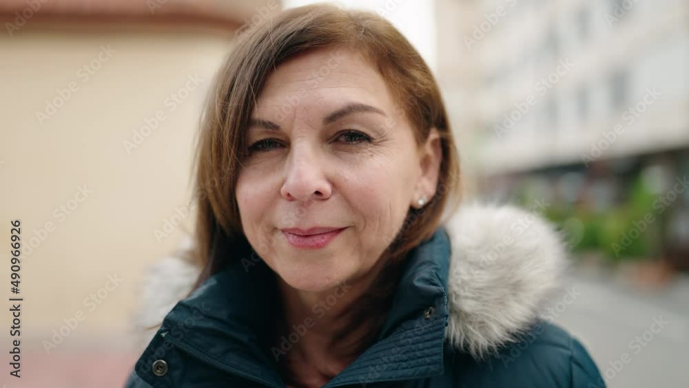 Middle age woman smiling confident standing at street Middle age woman smiling confident standing at street