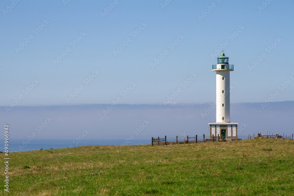 Lastres lighthouse on the coast facing the sea 