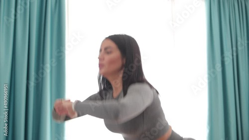 female butt workout squats at home. Athletic Woman squats workout in living room. Female gymnastics. Glutes workout motivation. Fitness at home concept.