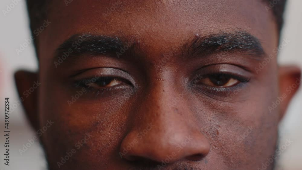 Close-up macro portrait of natural beauty young beautiful african american man's eyes, looking at camera. Brown eyes of man face, guy male model. Boy opening blinking his eyes. Slow motion 4k footage Close-up macro portrait of natural beauty young beautiful african american man's eyes, looking at camera. Brown eyes of man face, guy male model. Boy opening blinking his eyes. Slow motion 4k footage