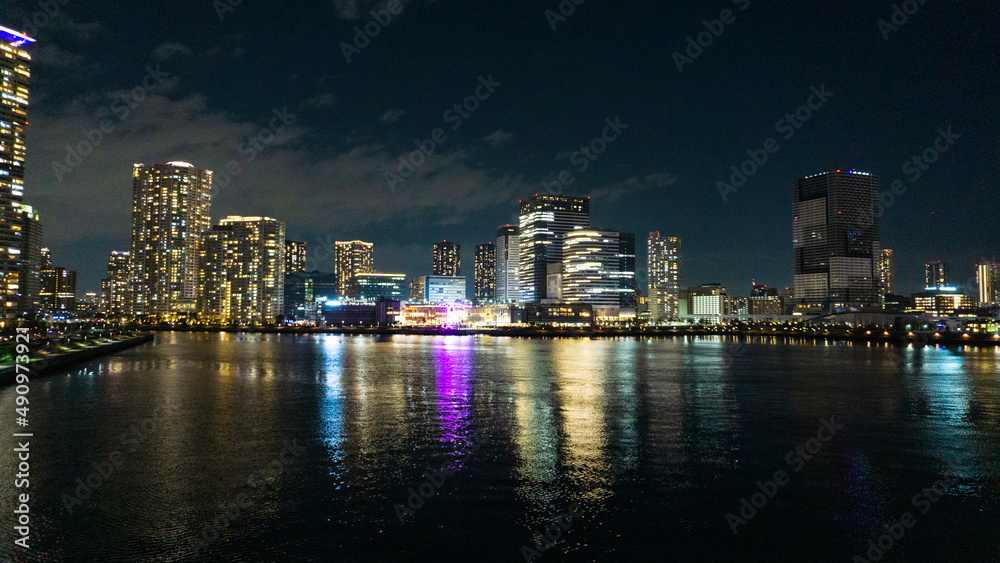 Night view of a high-rise condominium along an urban river_31