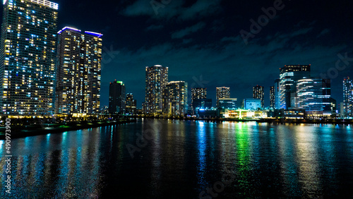 Night view of a high-rise condominium along an urban river_28
