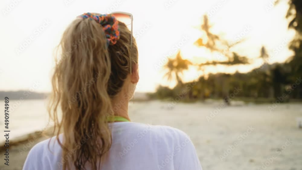 Blur mist glow cinematic close up portrait woman in a white tunic shirt on beach, near stormy sea. Attractive girl with wet curly hair, in sunglasses. Female tourist walks has fun rest at sunset Blur mist glow cinematic close up portrait woman in a white tunic shirt on beach, near stormy sea. Attractive girl with wet curly hair, in sunglasses. Female tourist walks has fun rest at sunset