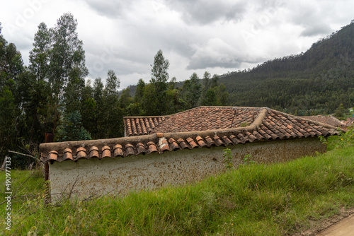 Old country house with a clay tile roof in the middle of the forest. Colombia .