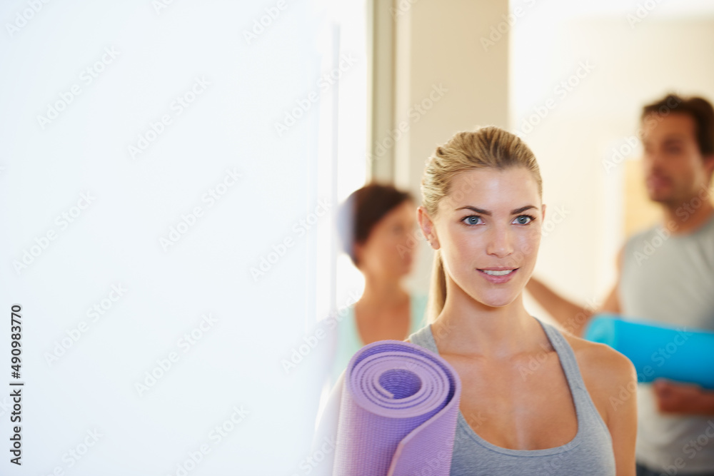 Dedicated to holistic fitness. Shot of a beautiful young woman on her way to yoga class.