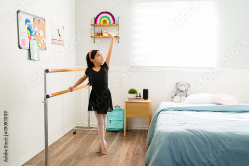 Elementary girl doing ballet in her bedroom
