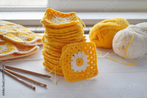 Crochet handmade granny square pattern, crocheting supplies, assorted colored wool yarn, hook, knitting crocheting