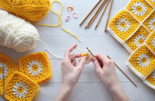 Crochet handmade granny square pattern, crocheting supplies, assorted colored wool yarn, hook, knitting crocheting