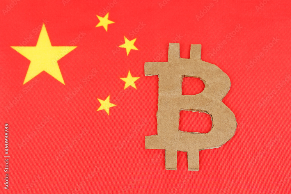 On the background of the flag of China lies the symbol of bitcoin.