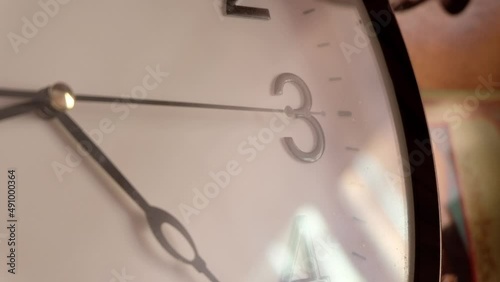 White clock face ticking stock footage. black numerals on white dial, time goes by on the clock. Clock close up