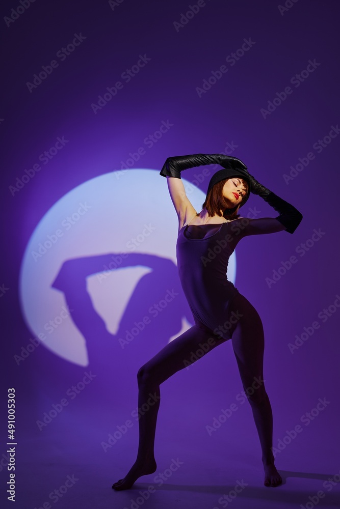 Pretty young female posing on stage spotlight silhouette disco color background unaltered