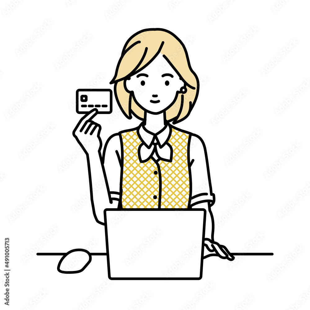 デスクで座ってPCを使いながらクレジットカードを手に持っている事務員制服の女性