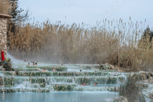 The natural spa of Saturnia, Grosseto, Italy, with people bathing in the thermal waters