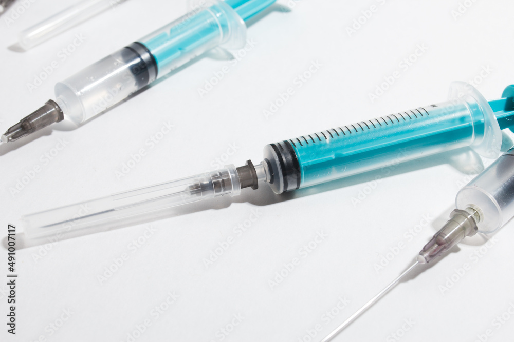 Medical syringe on a white background. A syringe for injection. The concept of health and beauty Medical syringe on a white background. A syringe for injection. The concept of health and beauty
